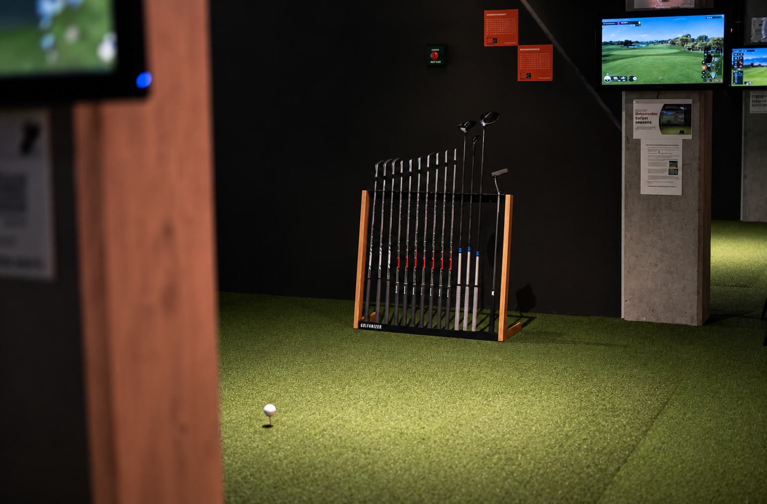 Golfanizer rack beside a private indoor golf simulator